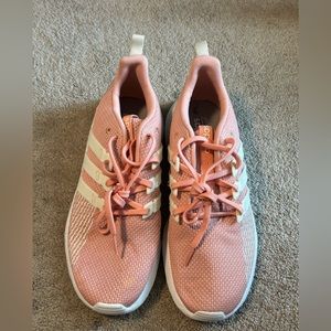 Pink and white adidas running shoes.